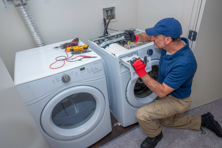 Appliance technician working on washing machine